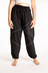 Emily is wearing the Black Himal Contrast Stitch Sweatpants in S/M