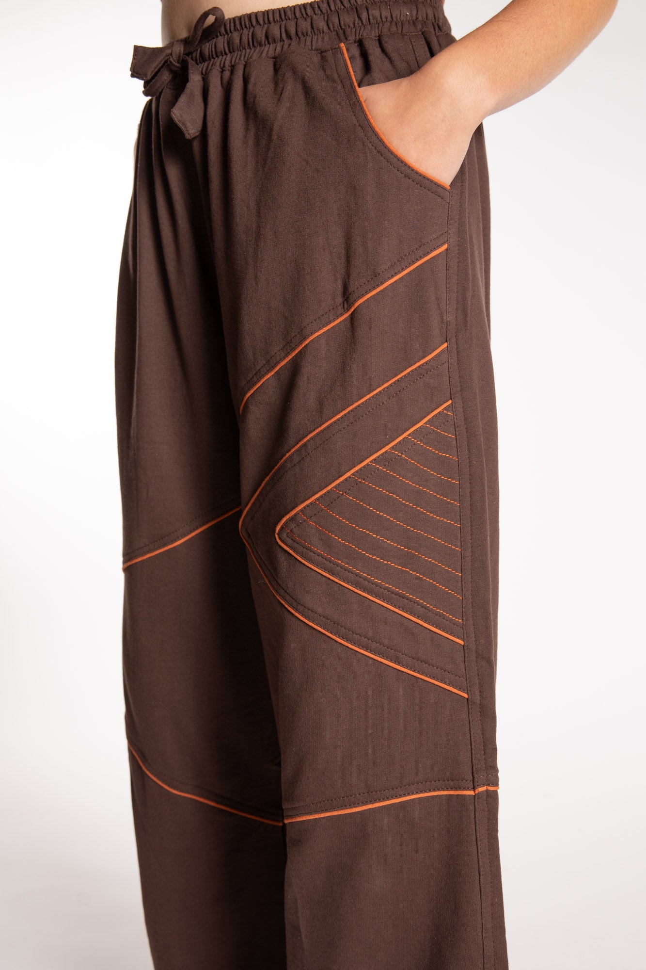 Emily is wearing the Brown Himal Contrast Stitch Sweatpants in S/M