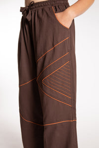 Emily is wearing the Brown Himal Contrast Stitch Sweatpants in S/M