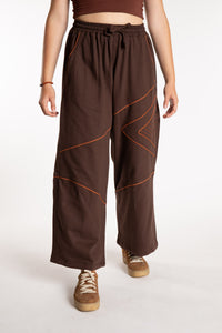 Emily is wearing the Brown Himal Contrast Stitch Sweatpants in S/M