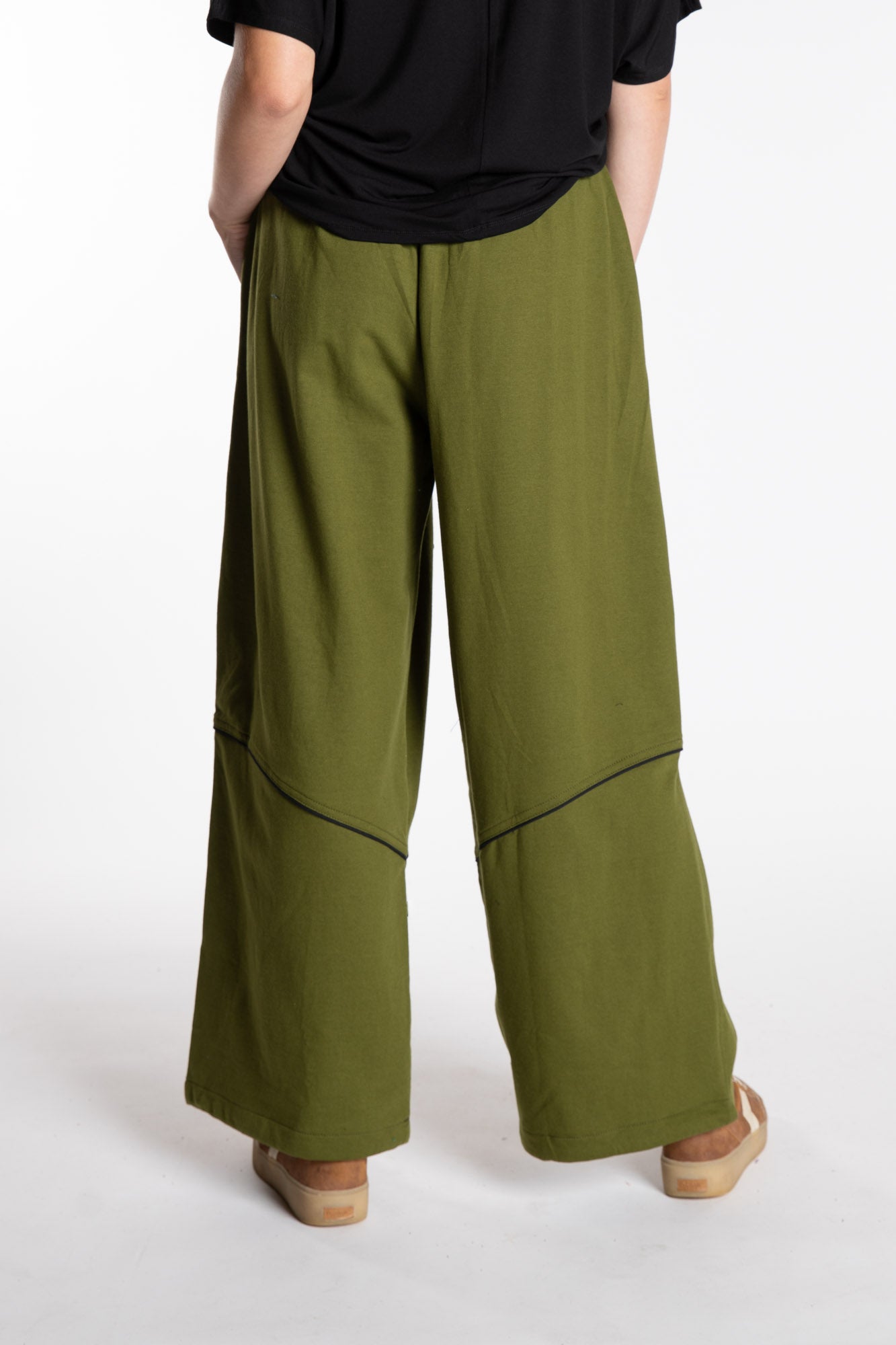 Emily is wearing the Green Himal Contrast Stitch Sweatpants in S/M