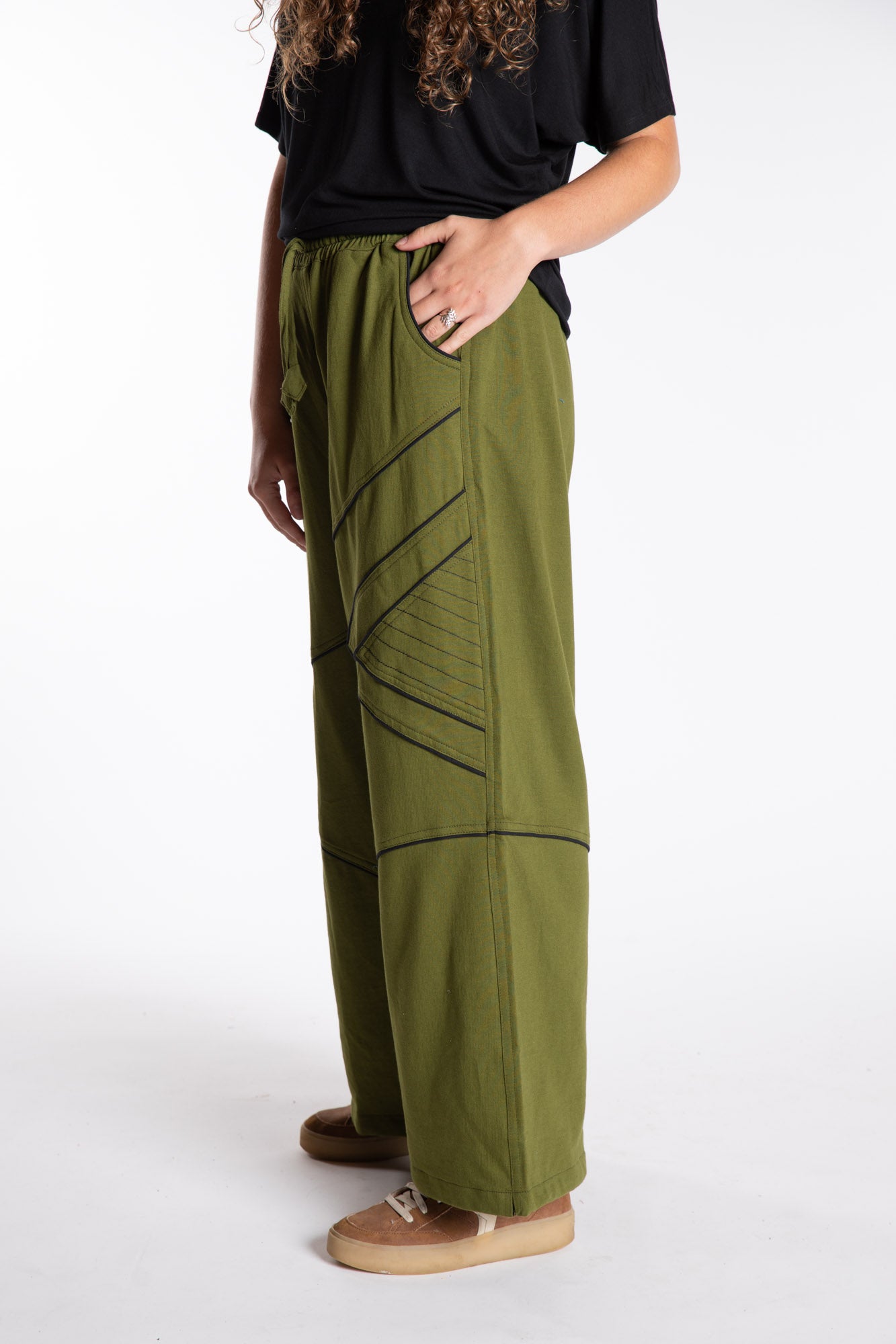 Emily is wearing the Green Himal Contrast Stitch Sweatpants in S/M