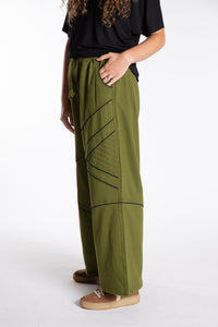 Emily is wearing the Green Himal Contrast Stitch Sweatpants in S/M