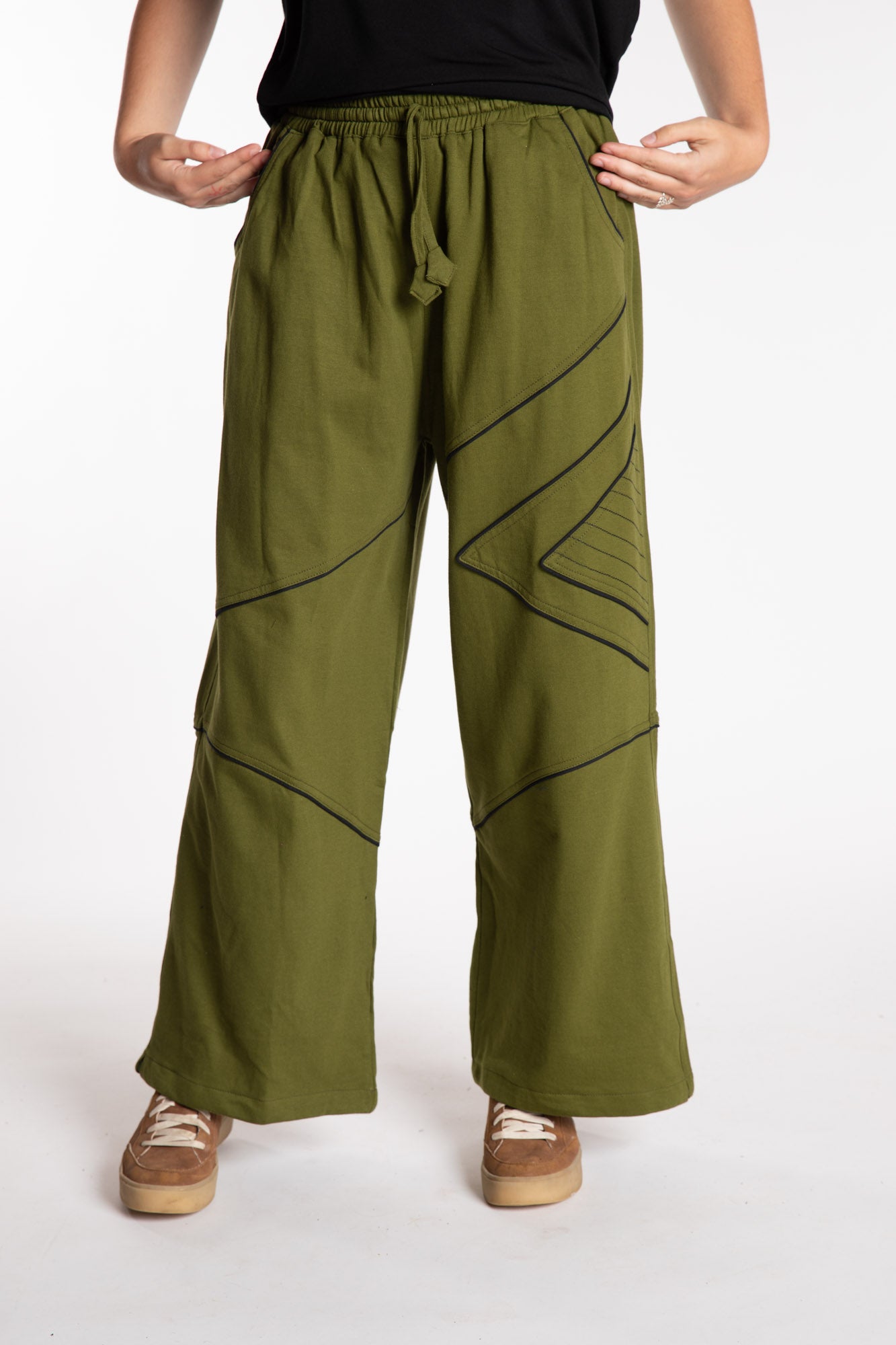 Emily is wearing the Green Himal Contrast Stitch Sweatpants in S/M