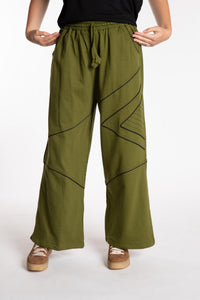Emily is wearing the Green Himal Contrast Stitch Sweatpants in S/M