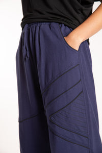 Emily is wearing the Navy Himal Contrast Stitch Sweatpants in S/M