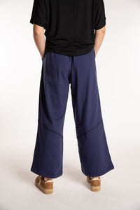 Emily is wearing the Navy Himal Contrast Stitch Sweatpants in S/M