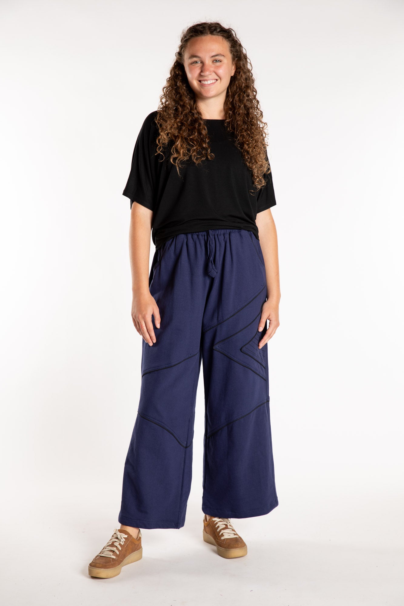 Emily is wearing the Navy Himal Contrast Stitch Sweatpants in S/M