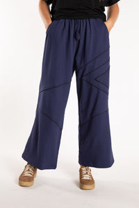 Emily is wearing the Navy Himal Contrast Stitch Sweatpants in S/M