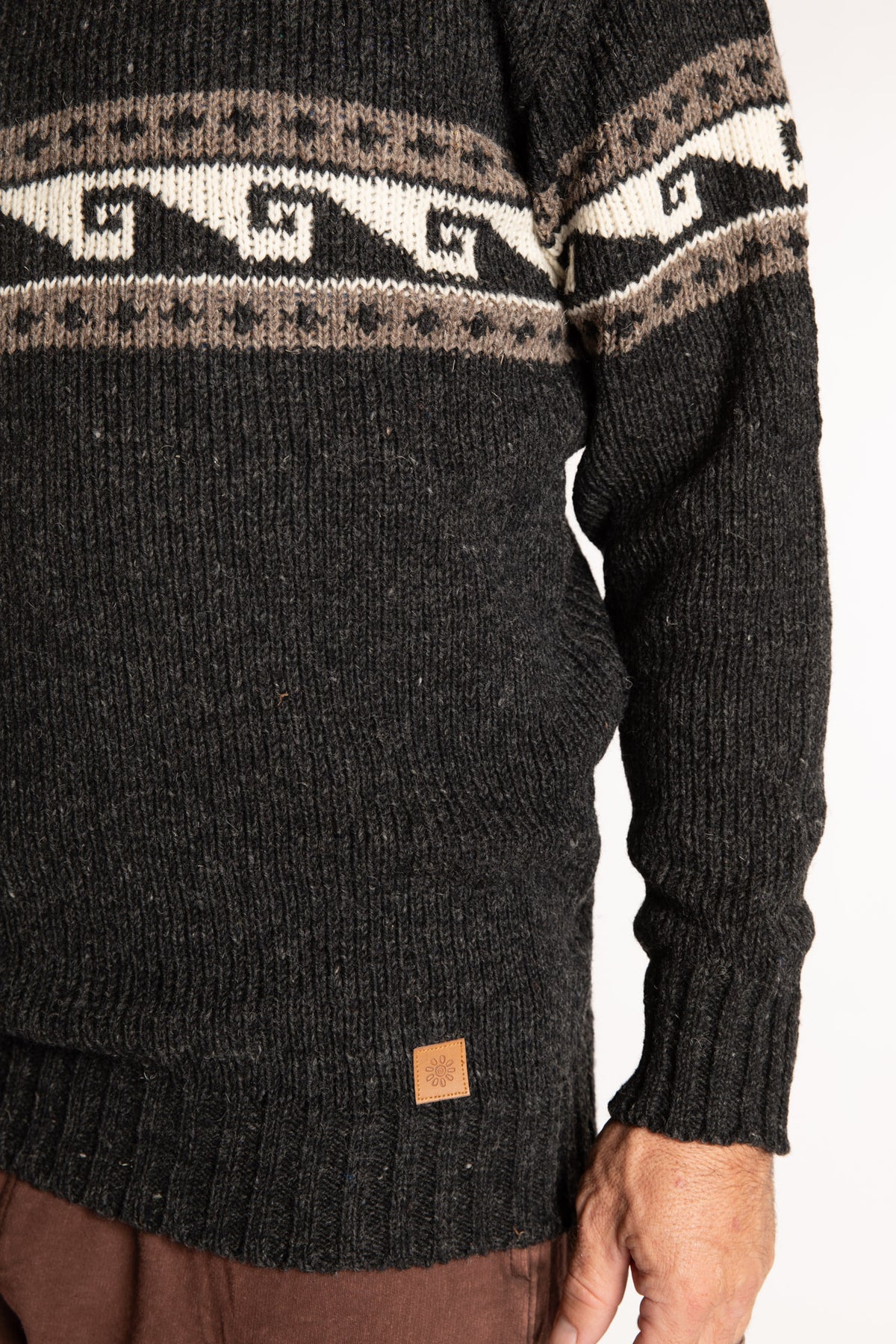 Topher is wearing the Large Himalayan Patterned Wool Sweater in Charcoal Wave