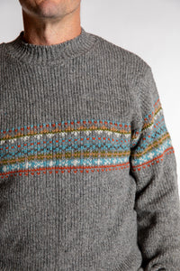 Topher is wearing the Large Himalayan Patterned Wool Sweater in Natural Multi