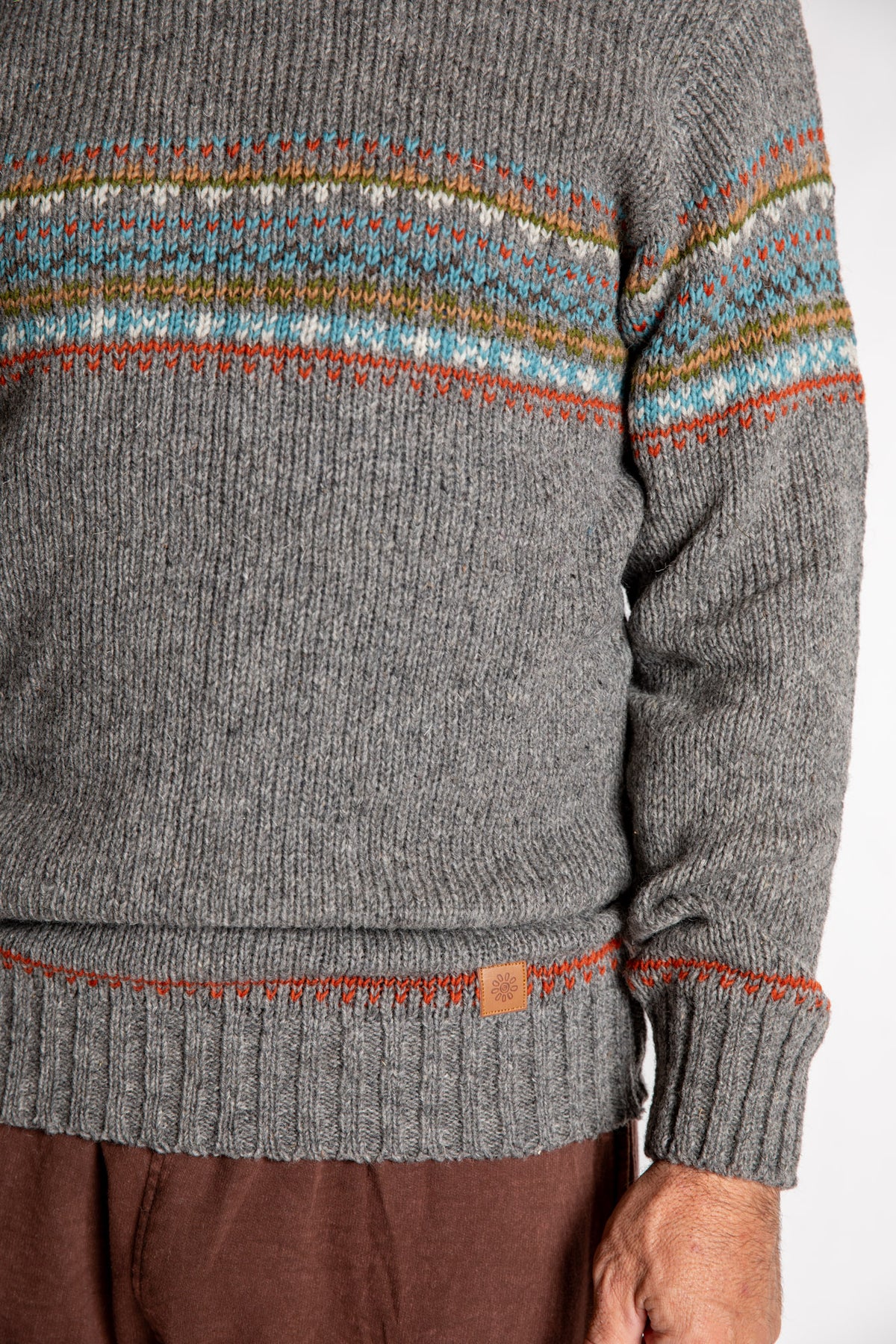 Topher is wearing the Large Himalayan Patterned Wool Sweater in Natural Multi