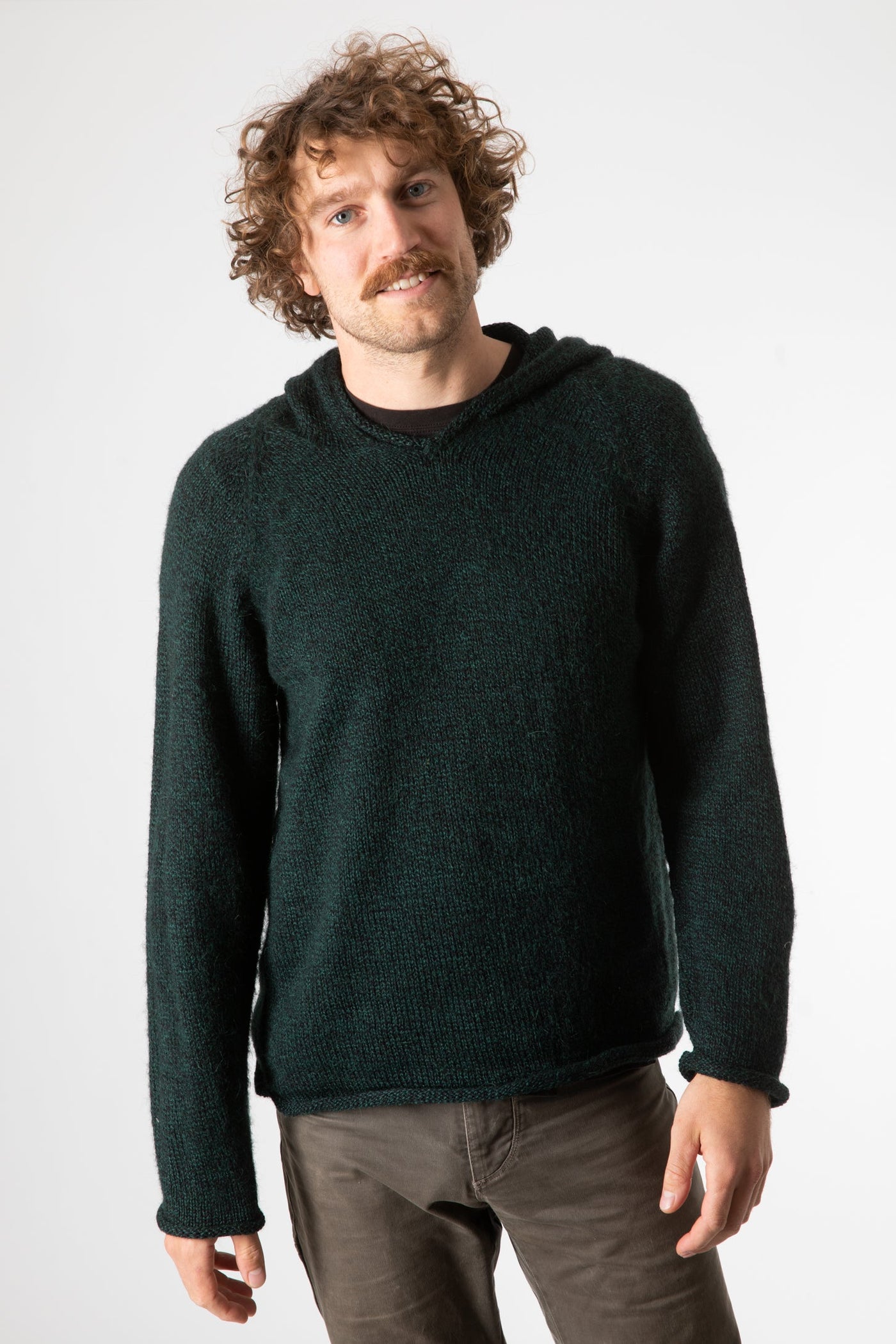 Ryan is wearing size L alpaca hoodie in forest