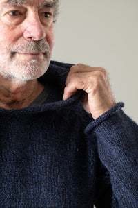 Bernie is wearing size L alpaca hoodie in navy