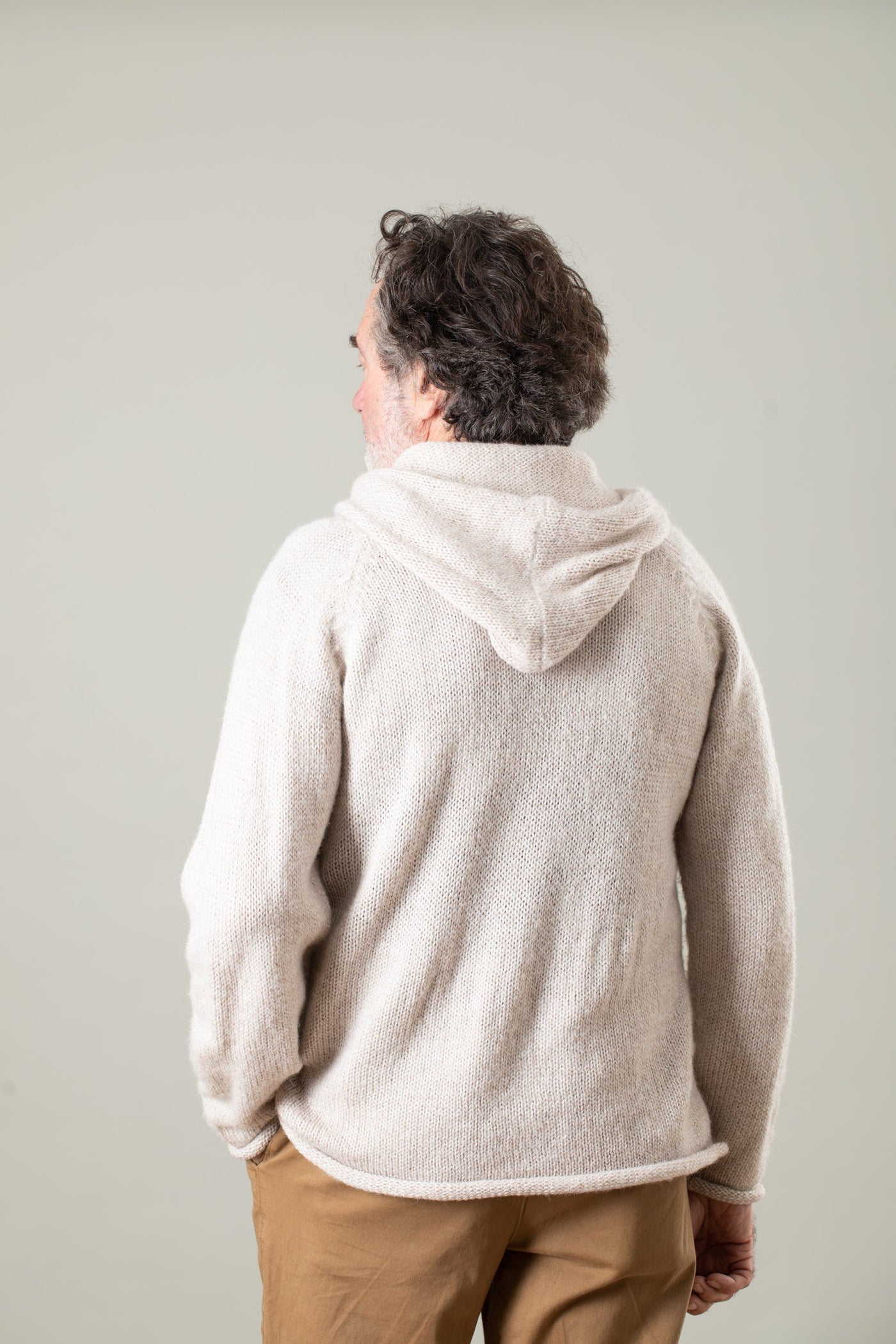 Bernie is wearing size L alpaca hoodie in oatmeal
