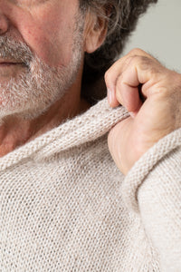 Bernie is wearing size L alpaca hoodie in oatmeal