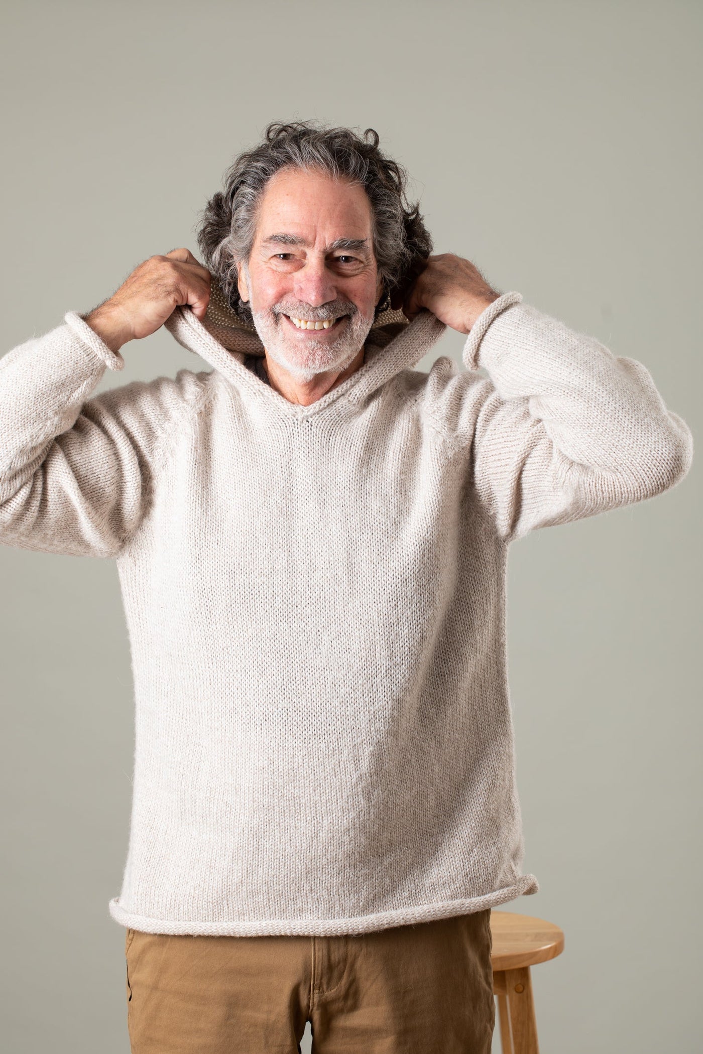 Bernie is wearing size L alpaca hoodie in oatmeal