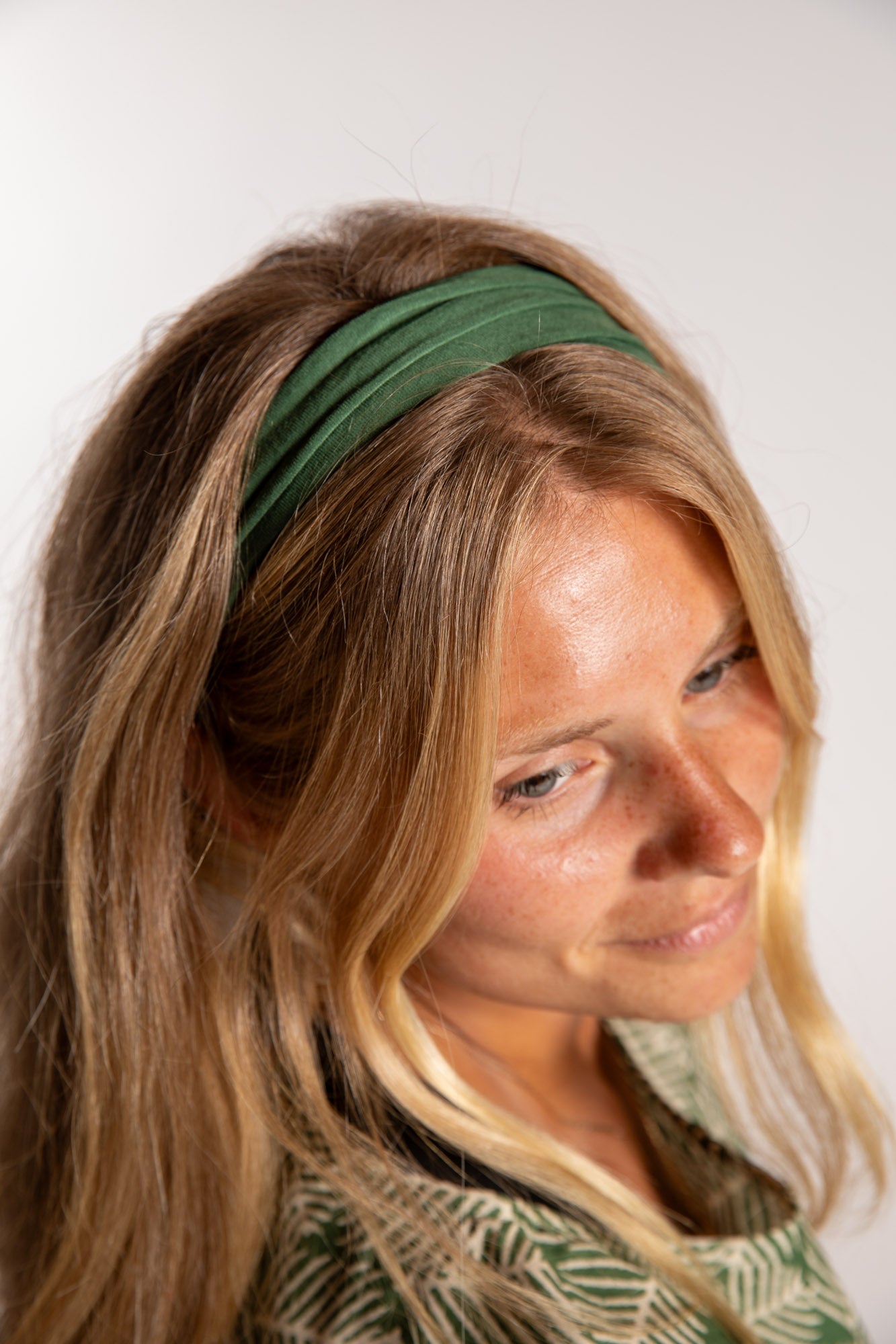 Sophie is wearing the Indra Stretch Headband in Olive