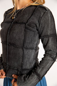 Sophie is wearing the Black Isha Seamed Mosaic Top in size small