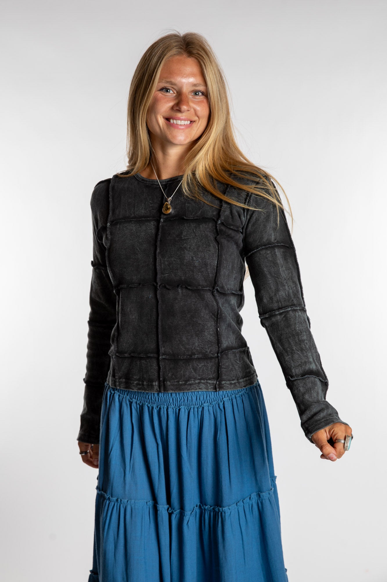 Sophie is wearing the Black Isha Seamed Mosaic Top in size small