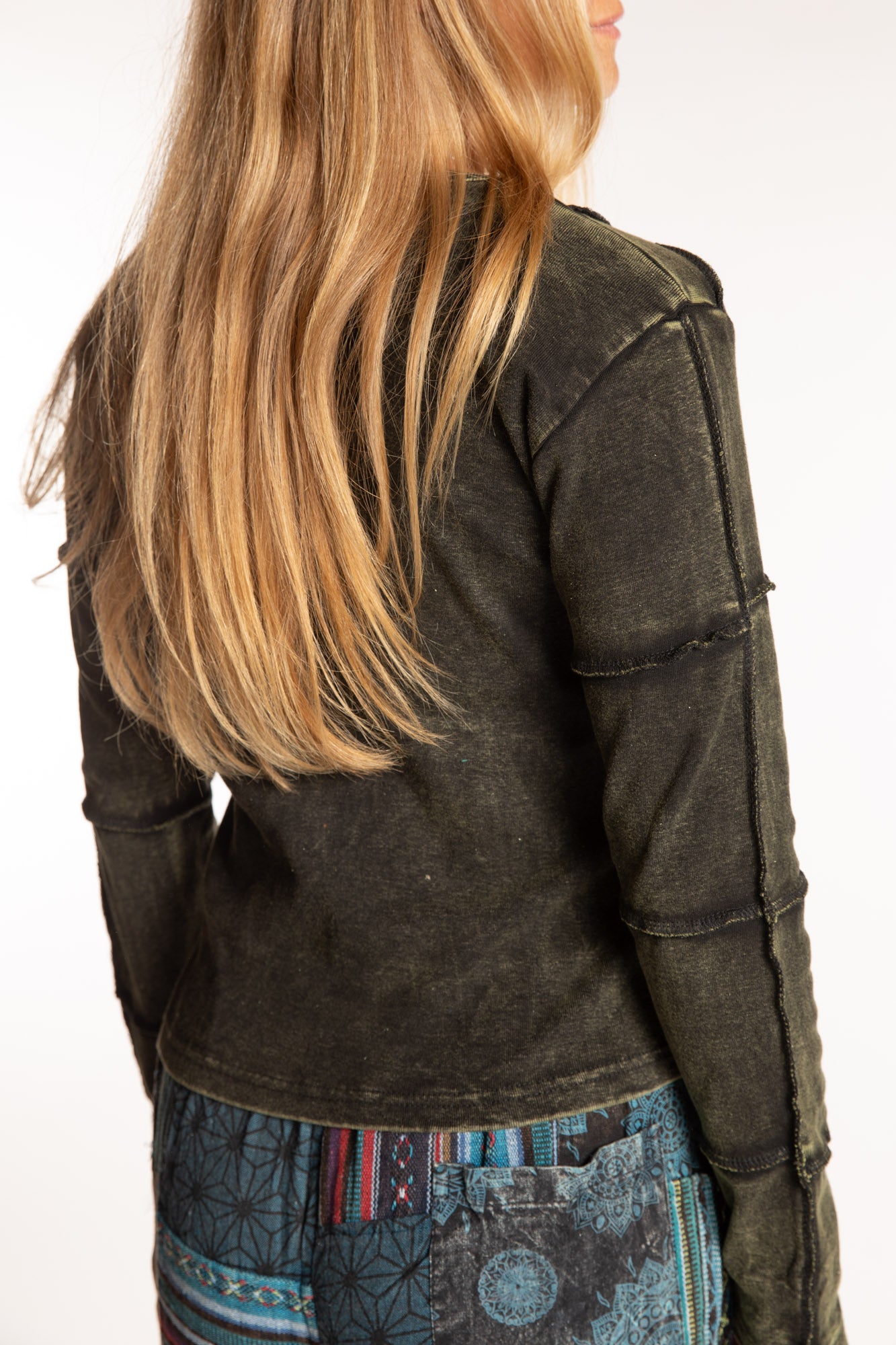 Sophie is wearing the Green Isha Seamed Mosaic Top in size small