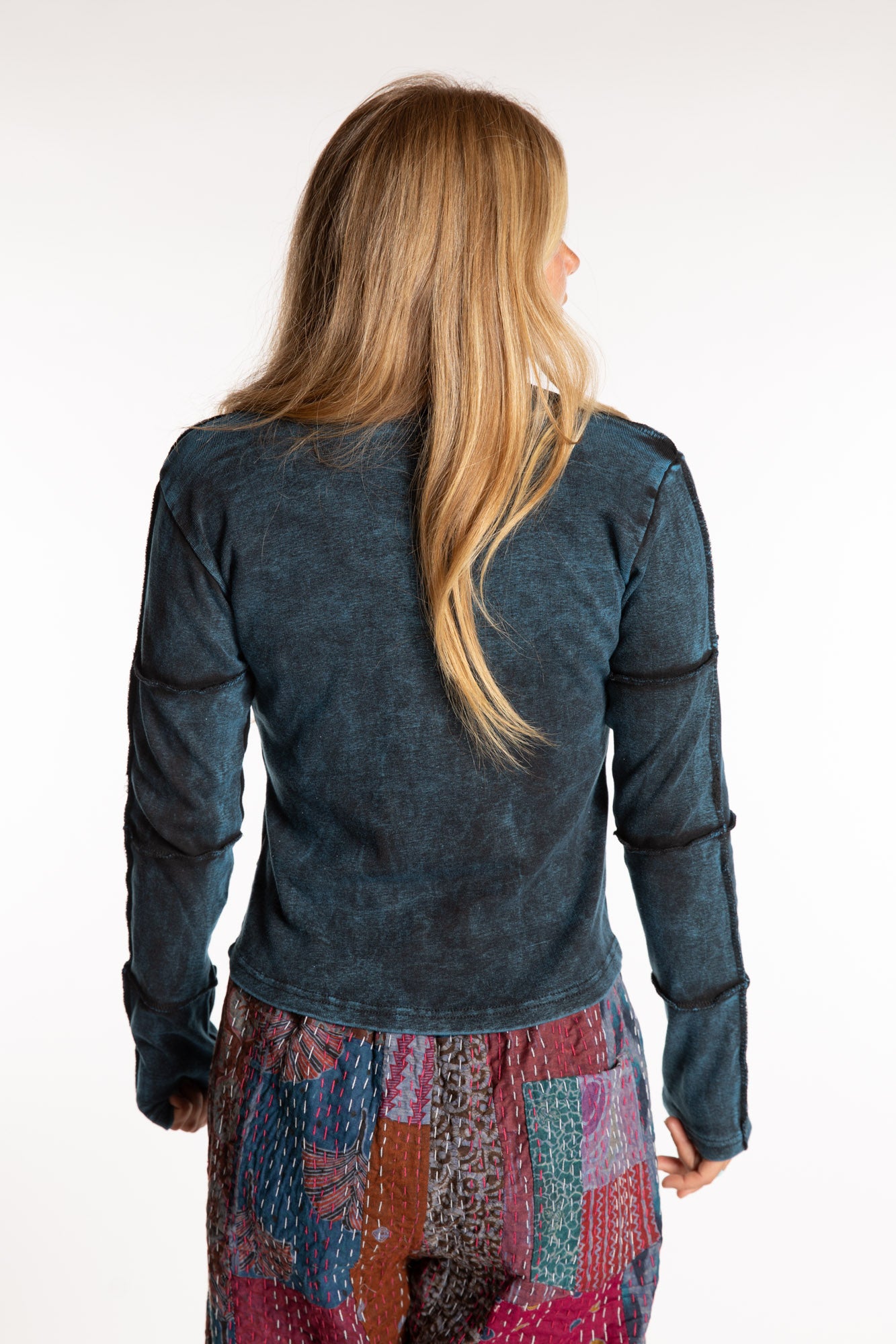 Sophie is wearing the Teal Isha Seamed Mosaic Top in size small