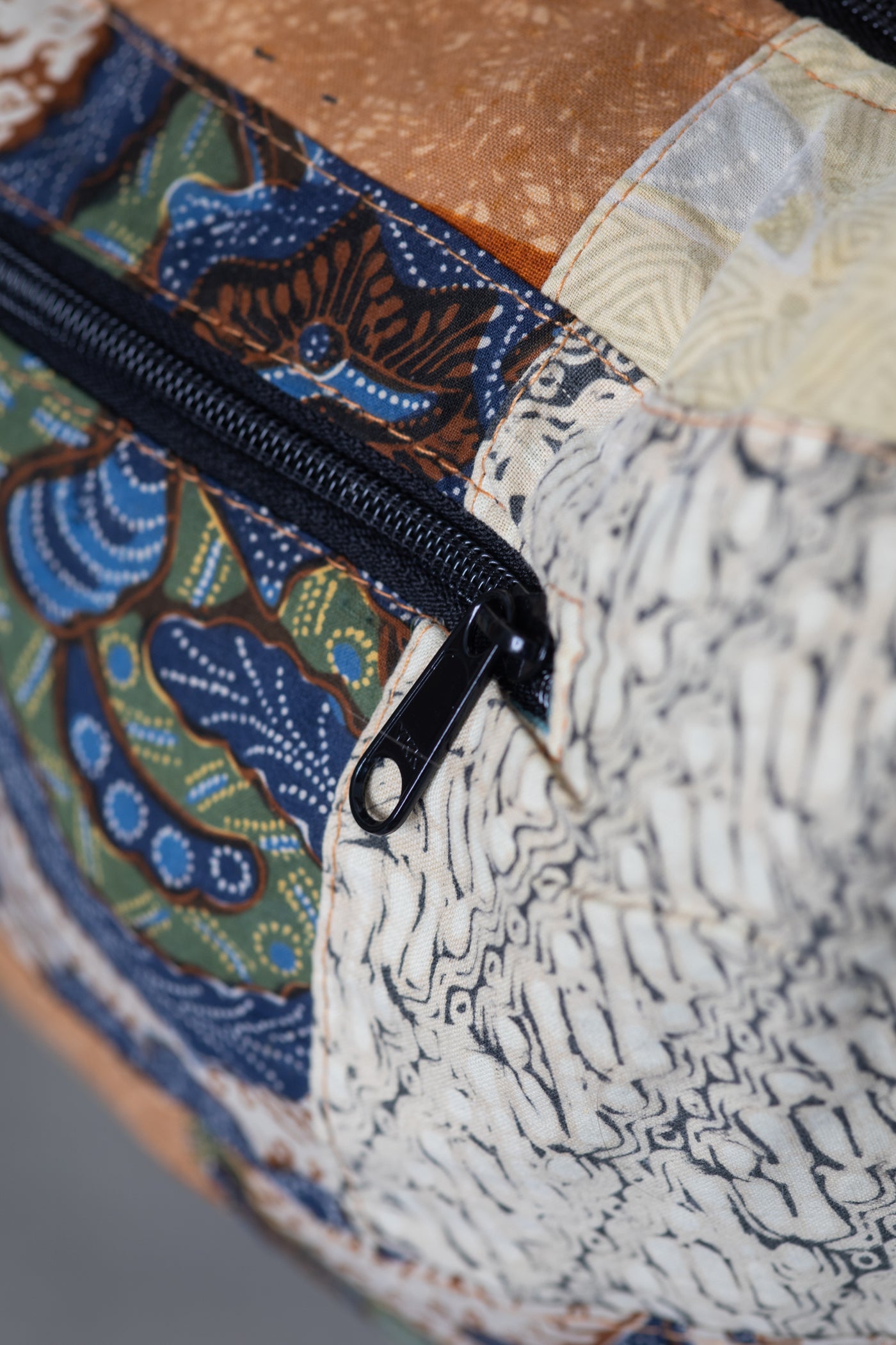 Assorted colorful patterned java patch moon bag detail of zipper