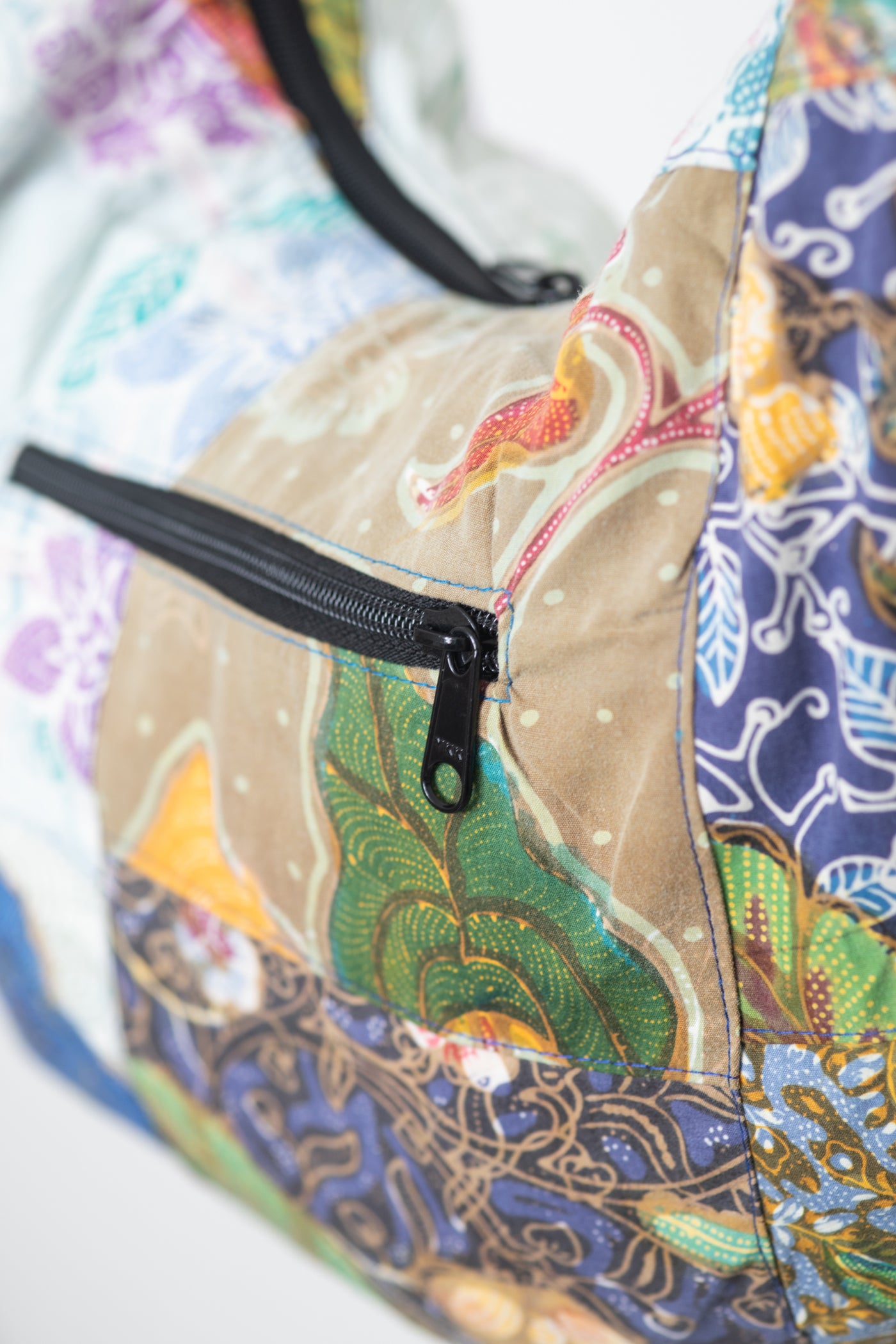 Assorted colorful patterned java patch moon bag detail of zipper