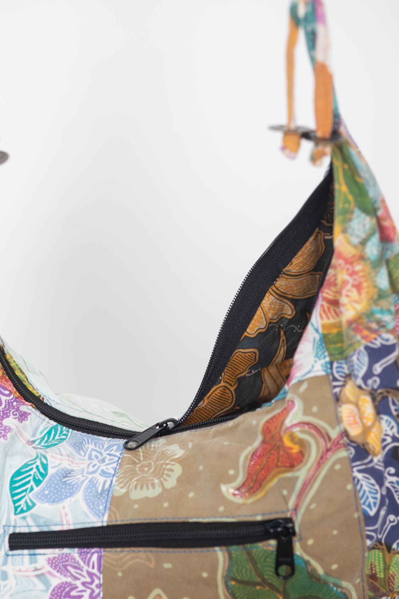 Assorted colorful patterned java patch moon bag detail of zipper