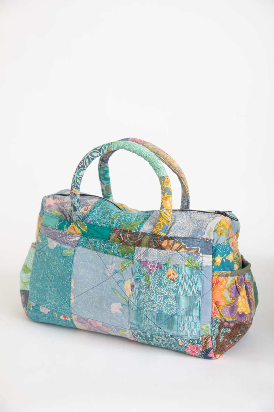 Multicolored patchwork weekend bag on a white background