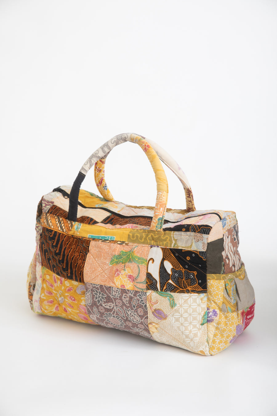 Assorted multicolor patchwork weekend bag on a white background