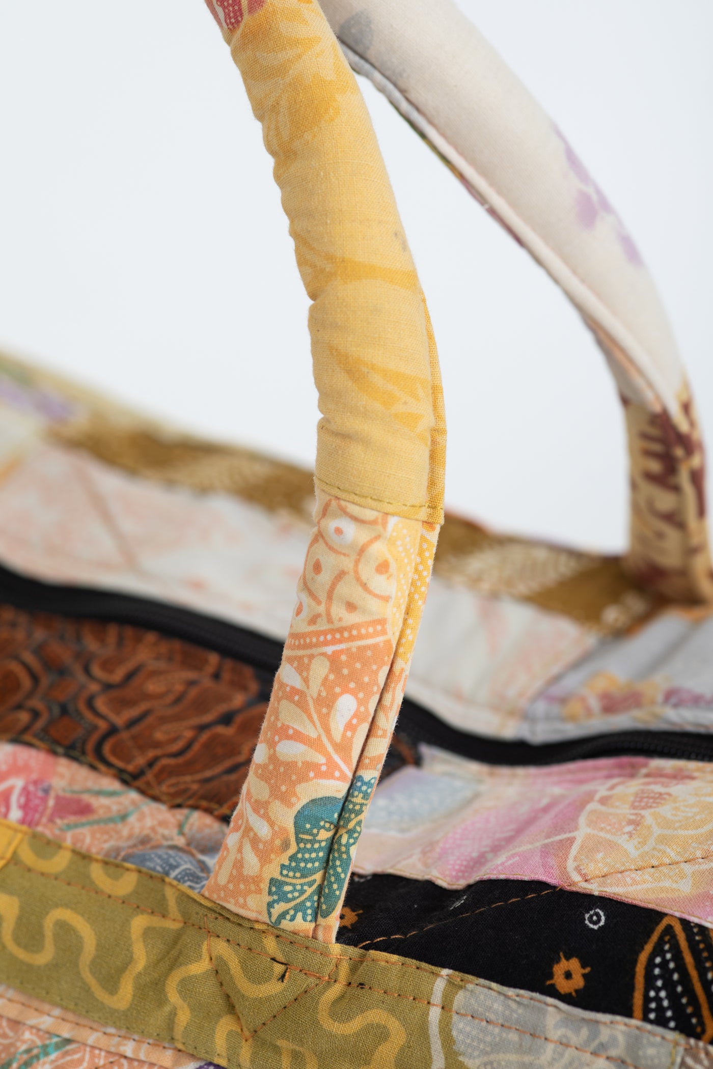 Assorted multicolor patchwork weekend bag detail of handle