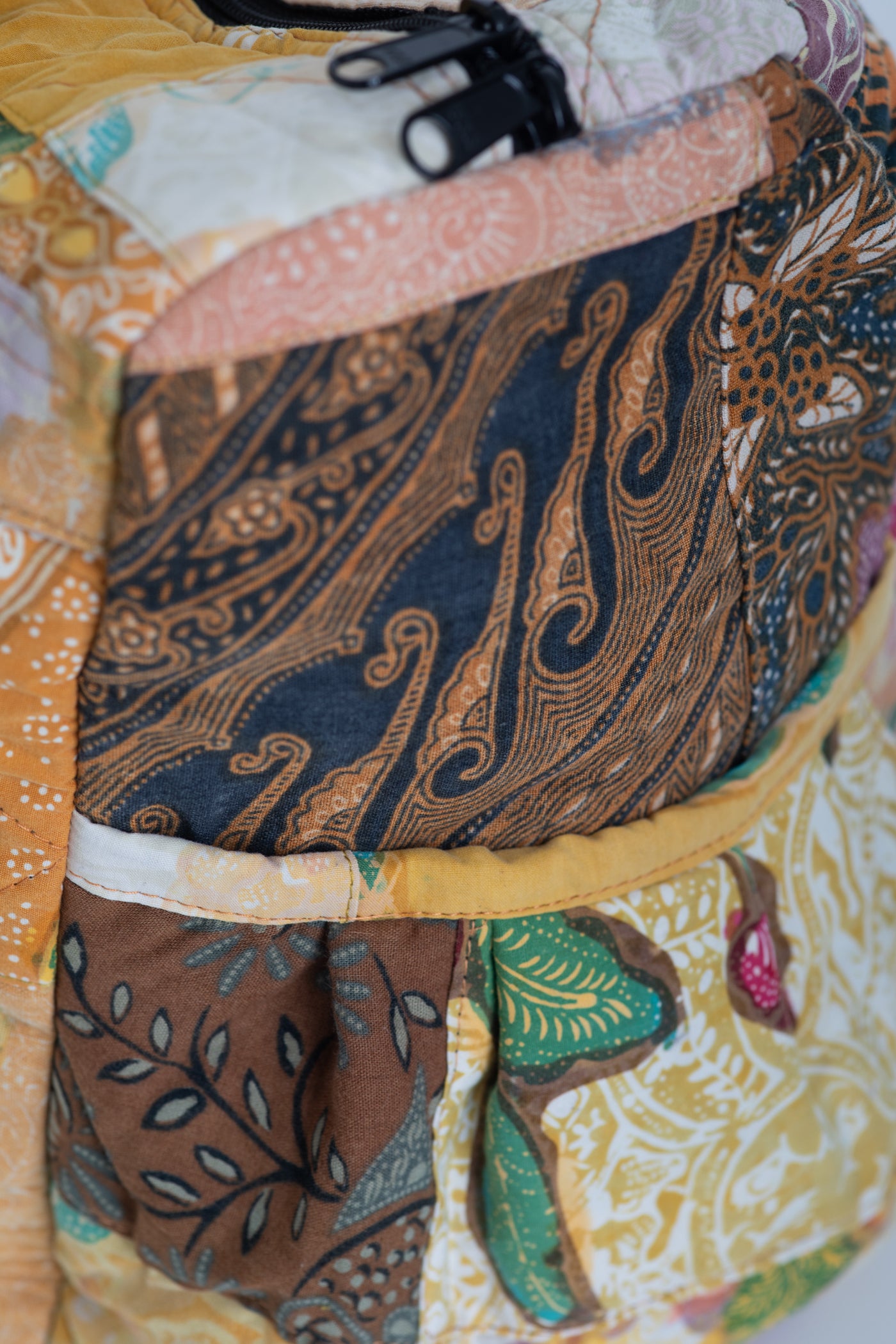 Assorted multicolor patchwork weekend bag detail of side pocket