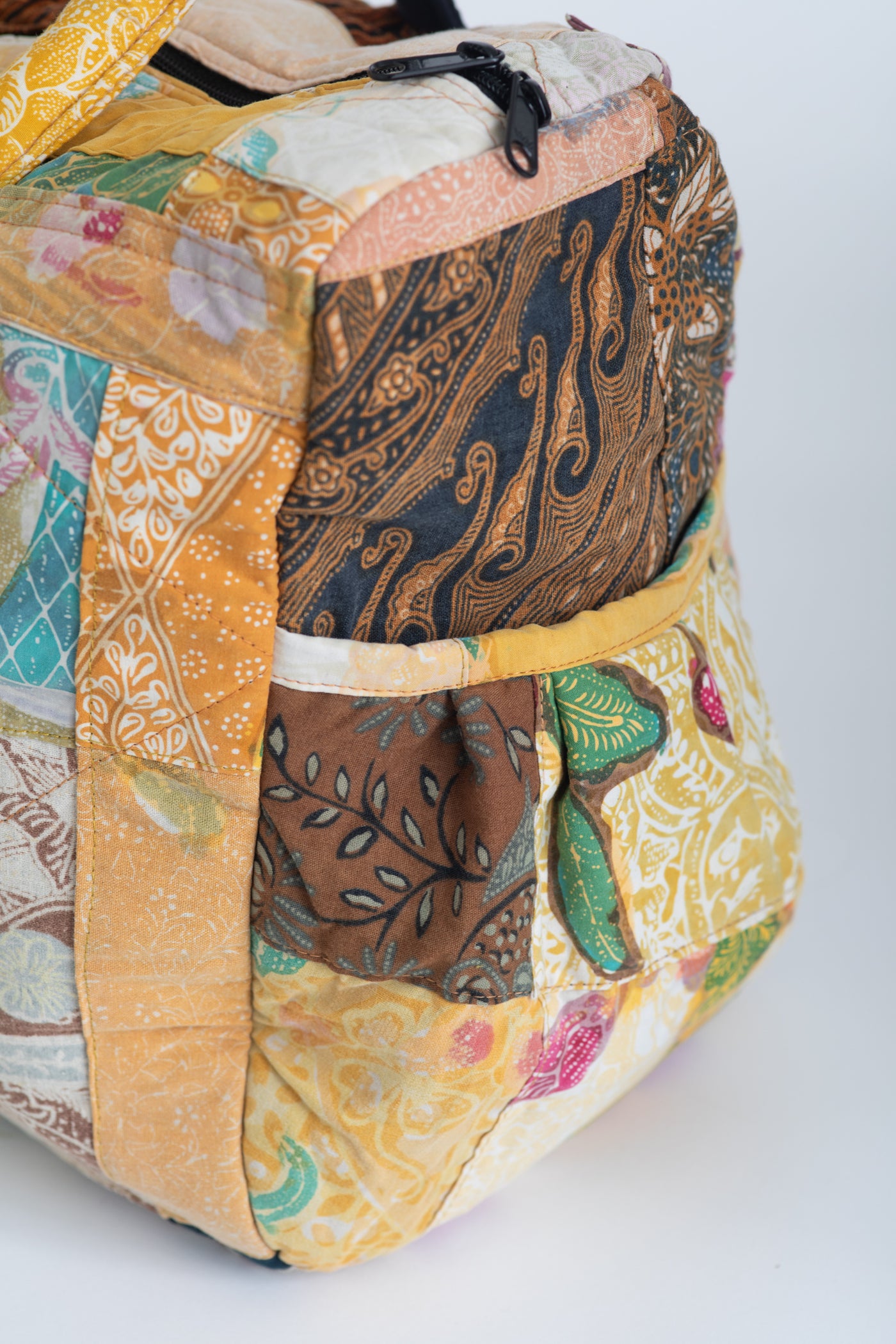 Assorted multicolor patchwork weekend bag detail of side pocket