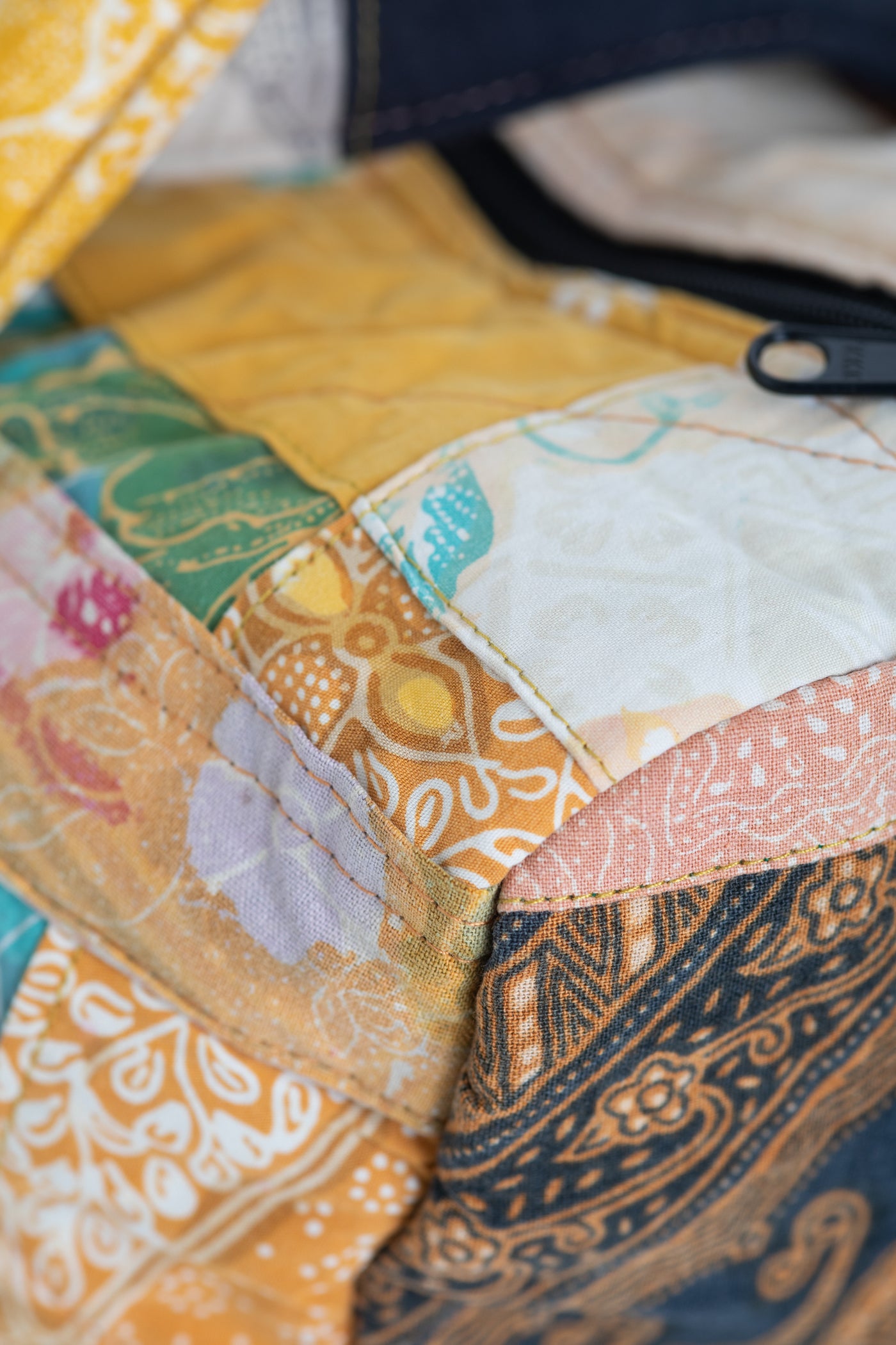 Assorted multicolor patchwork weekend bag detail of sewing