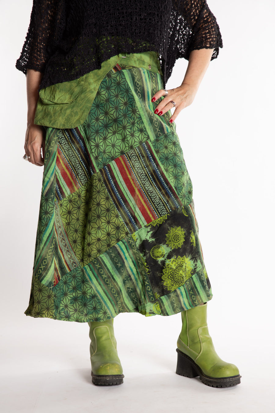 Susan is wearing a S/M Jaya Patchwork Utility Skirt in Green