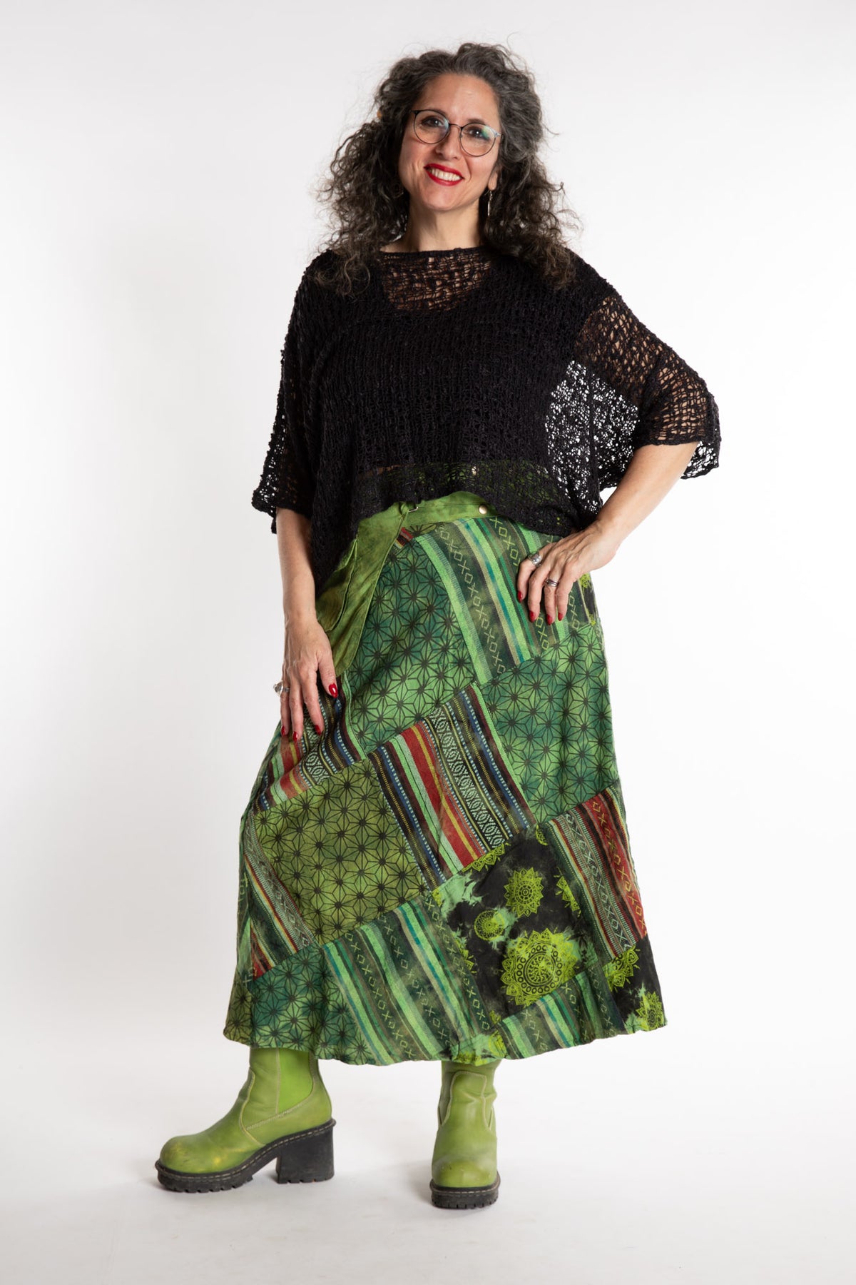 Susan is wearing a S/M Jaya Patchwork Utility Skirt in Green