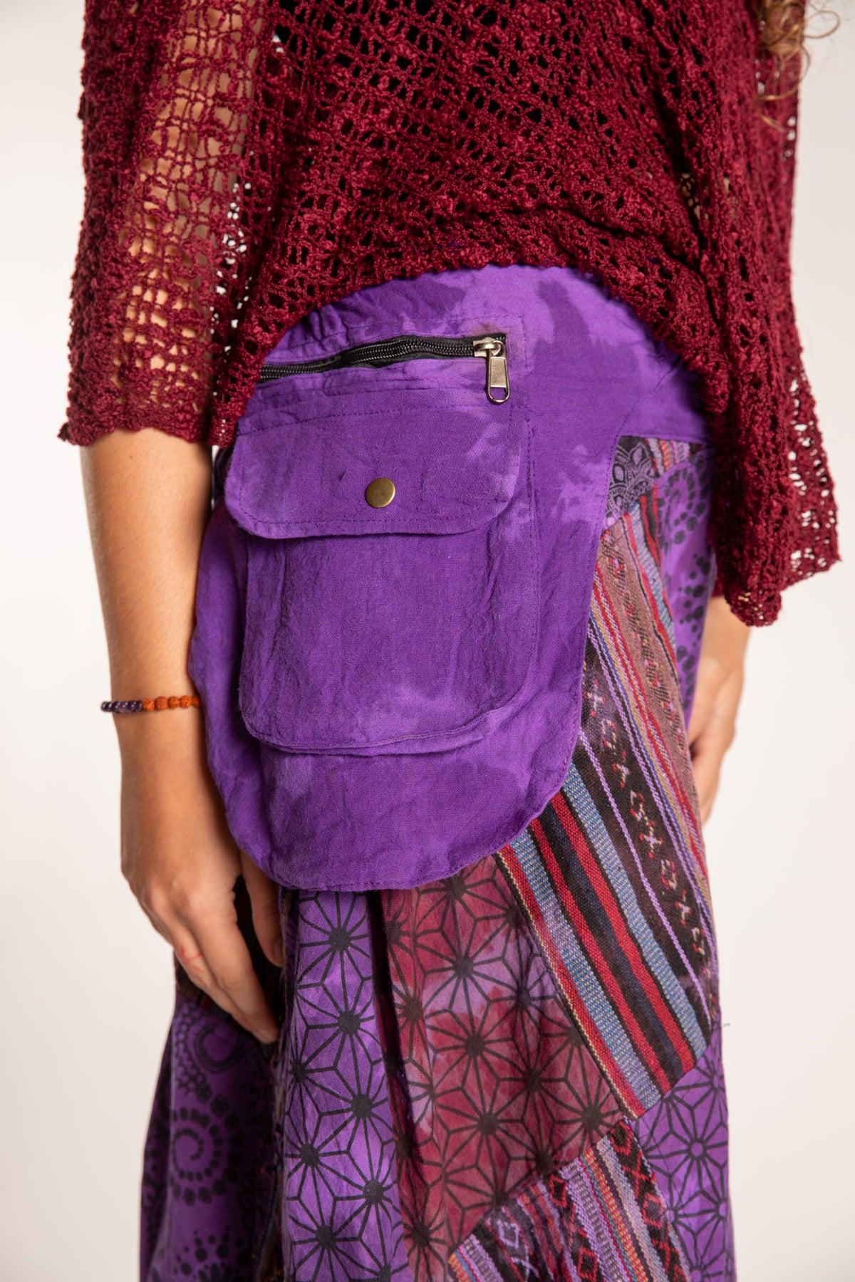 Emily is wearing the Purple Jaya Patchwork Utility Wrap Skirt in S/M