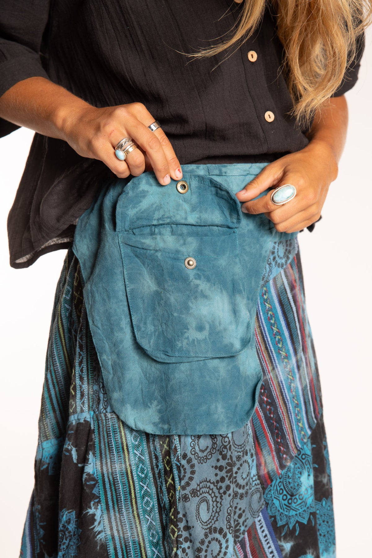 Sophie is wearing the Teal Jaya Patchwork Utility Wrap Skirt in S/M
