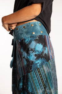 Sophie is wearing the Teal Jaya Patchwork Utility Wrap Skirt in S/M