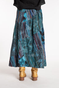 Sophie is wearing the Teal Jaya Patchwork Utility Wrap Skirt in S/M