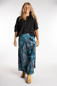 Sophie is wearing the Teal Jaya Patchwork Utility Wrap Skirt in S/M