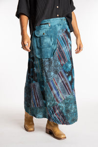 Sophie is wearing the Teal Jaya Patchwork Utility Wrap Skirt in S/M