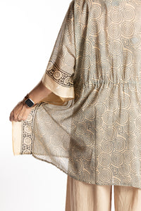 Betty is wearing the one size Kala Printed Cover Up in Gray