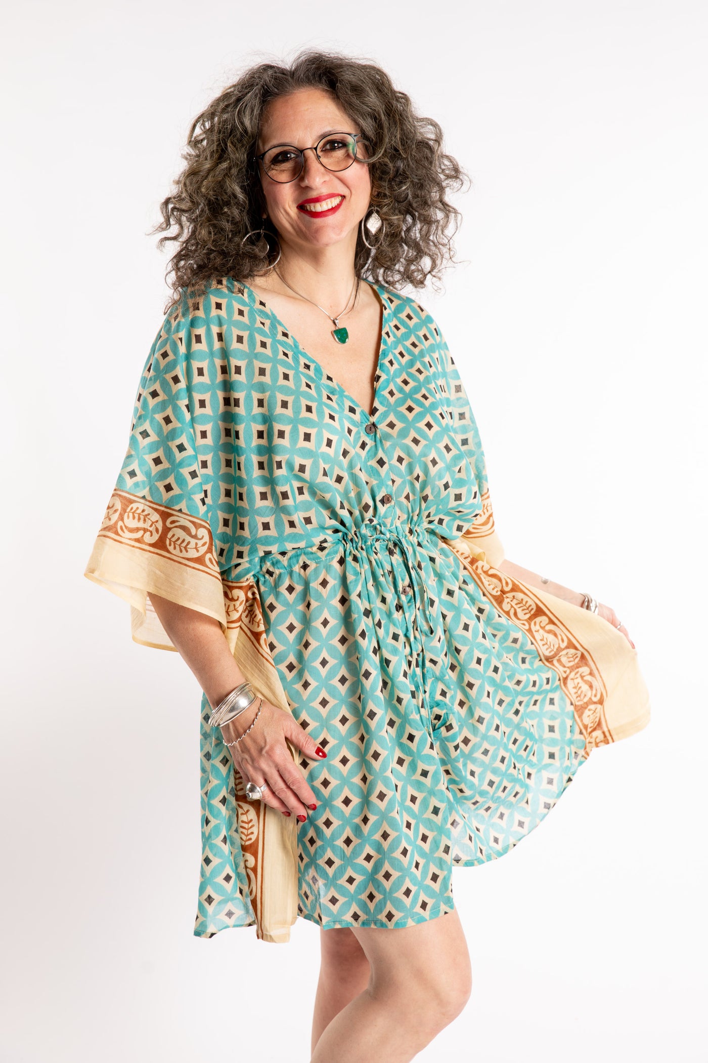 Susan is wearing the one size Kala Printed Cover Up in Teal