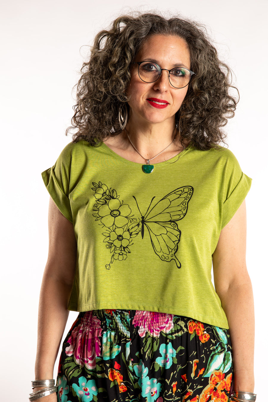 Susan is wearing the Kali Graphic Crop T in Clover in M/L