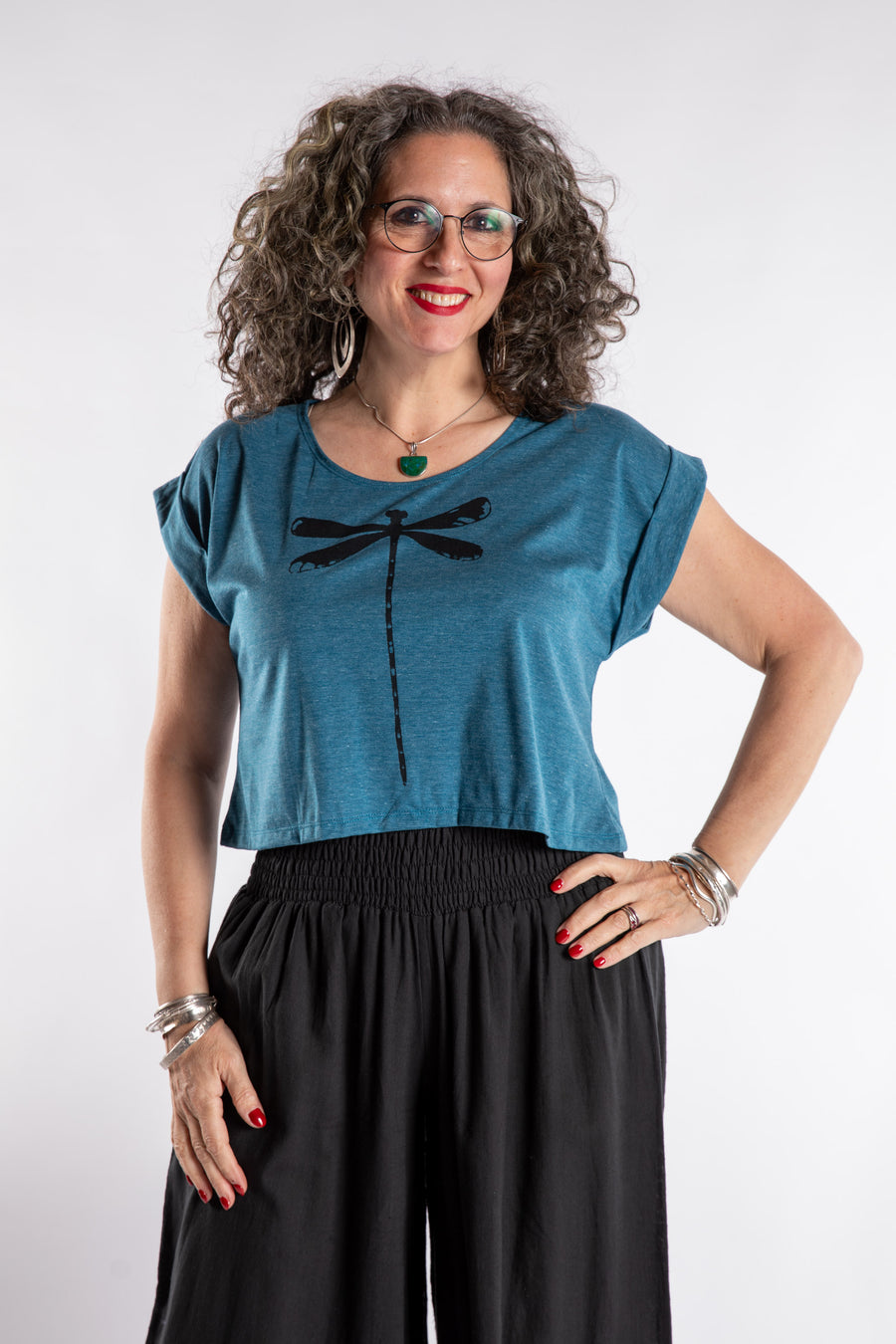 Susan is wearing the Kali Graphic Crop T in Lagoon in S/M