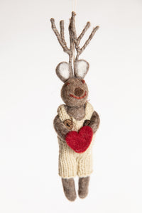 The front of a felted reindeer ornament with white overalls and a holding a felt heart