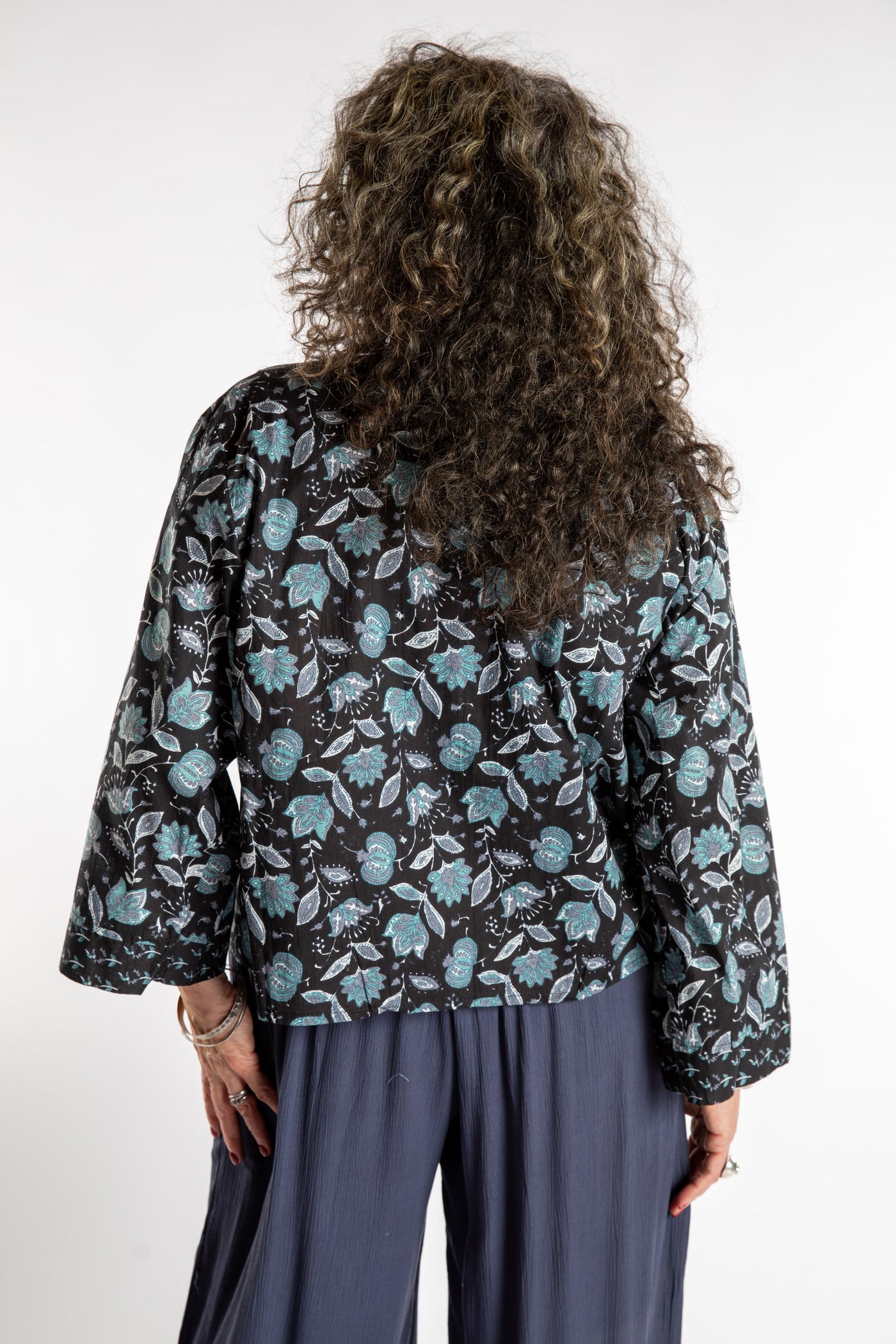 Susan is wearing the one size Kiraana cardigan in Black