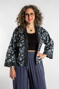 Susan is wearing the one size Kiraana cardigan in Black